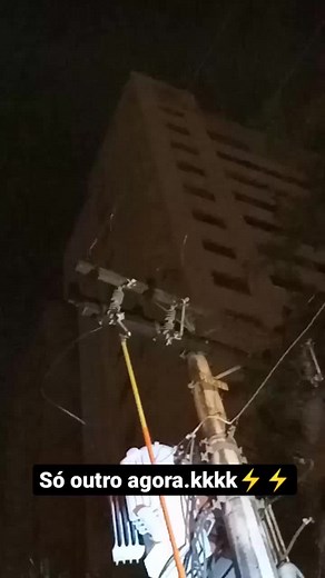 Inspecting Damaged Wires on an Urban Electrical Pole