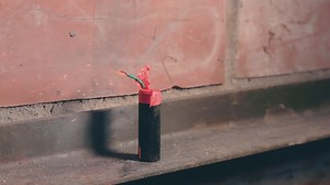 Download Firecracker Was Lighted Up With a Match then Explode Against a Brick Wall. Many Small Particles Flew in a Different Directions Static Shot for free