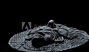 Sculpture in stone of face of ancient art south american aztec, inca, olmeca