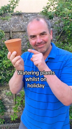 Using a porous terracotta pot to water your plants while you are away on holiday. Happy gardening