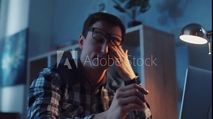 Young worker falls asleep on his workplace then gets up. Working hard, making money, income. Modern lifestyle, business. Slow motion, camera stabilizer shot, male portrait