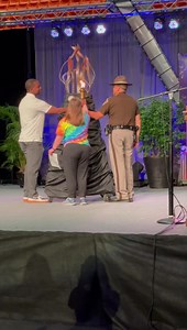 OHP Trooper Brandon Snyder, Special Olympics OKlahoma Athlete of the Year Lucy Kennon and Oklahoma State Men’s Basketball Coach Mike Boynton light the Flame of Hope, officially starting the SOOK Summer Games | Stillwater News Press
