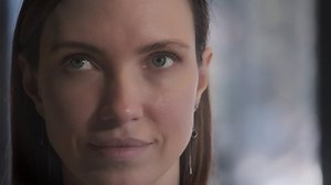 Closeup front woman, beautiful young human face, serious look at camera, open and confident. The girl smiles broadly with healthy white teeth. Close-up portrait of a beautiful girl.