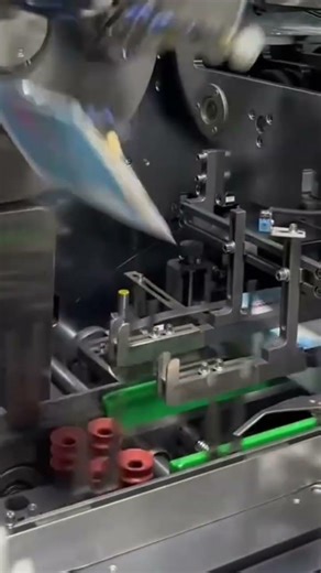 The process of making a packaging using advanced machinery in a factory by a worker