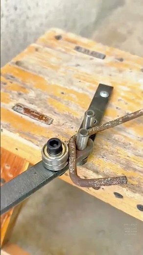 Manual bending of rusty steel rod using a homemade metal bending tool