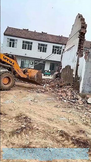 Tugging Unstable Masonry: How a Front Loader Safely Demolishes Freestanding Brick Walls