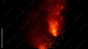 CLOSE UP: Stunning shot of Mount Yasur erupting at night and belching out glowing red magma. Dangerous molten lava and flames explode in the air during a violent volcanic eruption in Tanna, Vanuatu.