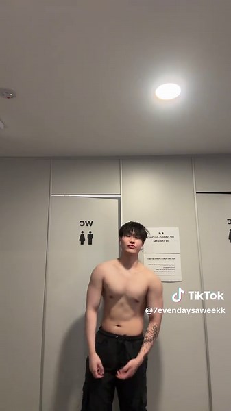 Muscular Male Poses in Modern Restroom Setting