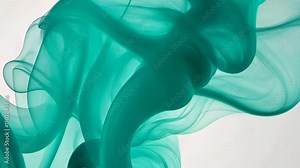 Swirling turquoise smoke creates an abstract visual masterpiece in soft lighting