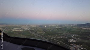 Airplane aircraft jet cockpit view final approach towards airport distance away from landing dusk evening travel transport aviation