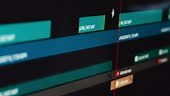 Closeup of a video editing timeline as the editor cuts clips to...