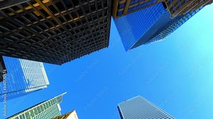 Panning Shot Of Directly Below View Of Tall Residential Buildings Under Clear Blue Sky On Sunny Day - Toronto, Canada
