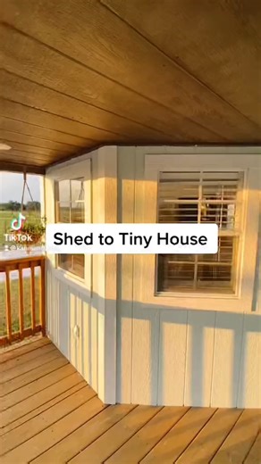 Would you live in this 12' x 36' shed converted into a tiny house? This tiny home was purchased as a shed by 20-year-old @katieelouie off FB marketplace & built into this incredible home for under $25,000! This tiny house features a cute front porch, an open living area with a couch & TV, a kitchen with apartment-size appliances, a full bathroom with a tile shower, a hallway with a washer/dryer & a large closet, & a small bedroom in the back of the tiny home! For more info on the build, check ou
