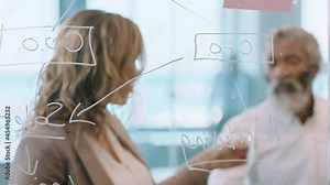 business people using sticky notes brainstorming team leader woman working with colleagues writing on glass whiteboard showing problem solving strategy in office meeting