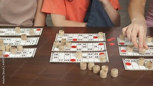 Traditional lotto. A family play traditional lotto russian game in the room.