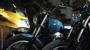 Biker garage with motorbikes. Close-up vintage and modern motorcycles kept in custom garage. Moto service interior. Tuning and restoration retro classic motorbikes. Old school moto technics exhibition