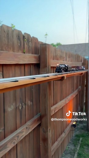 I set up an o gauge model train set on the privacy fence in my backyard #modeltrains #ogauge #gardentrain #toytrain