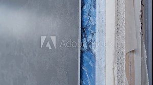 Colorful quartz and porcelain tile stone slab are standing in the factory warehouse. Kitchens and bathrooms countertop selection. Granite slabs are prepared for sale in store yard
