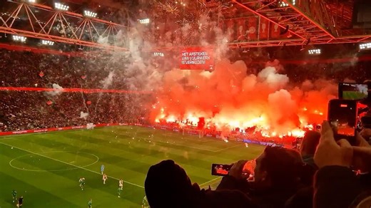 Ajax match abandoned after fans let off pyrotechnics in the stands