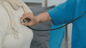 Download Close up of Female Doctor using stethoscope putting beat heart diagnose with patient in examination room at a hospital, check-up body, Medical and Health Care Concept. for free