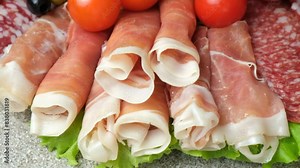 Meat platter - jamon, salami and other types of meat delicacies slow motion