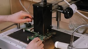 Repair of the computer motherboard, soldering the microchip with a soldering dryer.