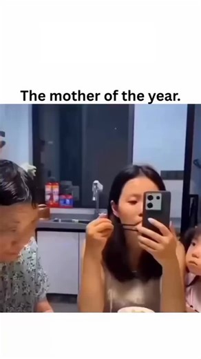 MeMo on Instagram: "The post features a reposted viral video from July 2025 depicting an Asian mother blindfolding her phone-distracted daughter with a yellow cloth during a family meal, captioned “The mother of the year” to celebrate witty parental intervention. - High engagement, including 17k+ likes and 600+ replies, reveals divided reactions: admiration for the mom’s resourcefulness contrasts with concerns about chronic family dynamics or AI generation due to minimal bystander responses. - T