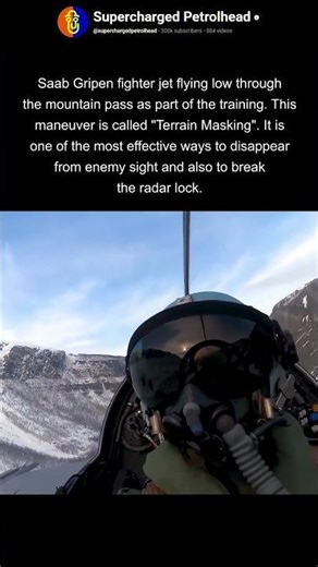 Fighter jet flying low between mountains