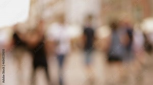 Blurred background of a crowded street, people and tourists are walking. Society and city life.