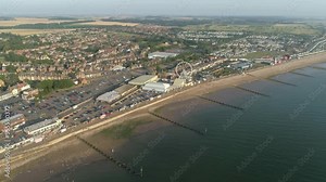 High Establishing Aerial Drone Shot Flying Forward Over Coastal Seaside Town New Hunstanton with Groynes along Sandy Beach and Ferris Wheel and Fun Fair with Calm Sea with Small Waves North Norfolk UK