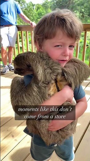 Why we travel with our kids! Hugging a sloth!