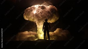 Nuclear war concept. Explosion of nuclear bomb. Creative artwork decoration in dark. People looking on giant mushroom cloud of atomic explosion. Selective focus