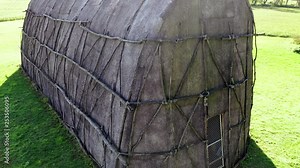 Aerial medium close of side and front of replica Native American Longhouse, Herr House property, Lancaster County, PA Concept: educational, replica, Native American culture, interactive exhibit