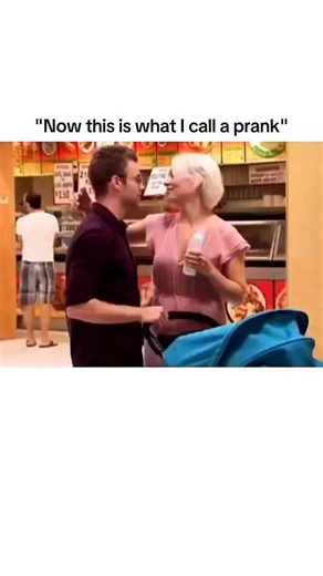 History | Entertainment | News on Instagram: "The post features a staged supermarket prank that escalates social chaos in seconds. A man stands in an aisle with his wife and baby before the wife briefly steps away, creating a setup window that viewers don’t notice at first. His “girlfriend” suddenly appears, forcing him into panic as he hands the baby’s bottle to a random shopper to avoid suspicion. She kisses him and presents a positive pregnancy test, triggering visible shock from nearby custo