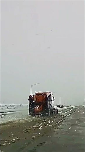 Large Snow Plow Truck vehicle clearing snow from the road