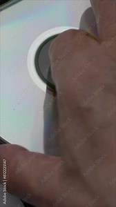 Blu-ray Disc Ejecting From Player. Unloading Compact Disc From The DVD Or CD Player. Vertical.