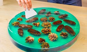 Handmade table of cones and books with epoxy resin