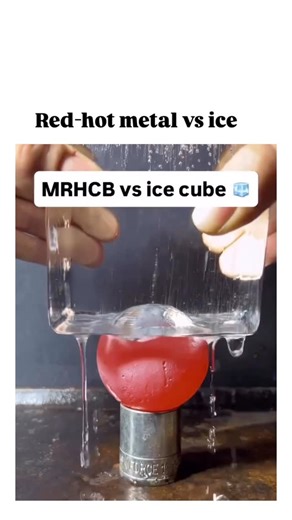 REELORAMA on Instagram: "- The video shows a red-hot metal ball sinking effortlessly through an ice cube, melting a precise spherical hole via intense localized heat conduction, a classic physics demonstration originating from experiments around 2013. - High thermal conductivity of the metal (likely nickel, heated to ~800°C) transfers energy rapidly to the ice at 0°C, overcoming its latent heat of fusion without causing cracks, as the melt zone expands uniformly. - Shared by science curator @Rai