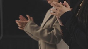 Download Two businesswomen clapping in front of a screen for free