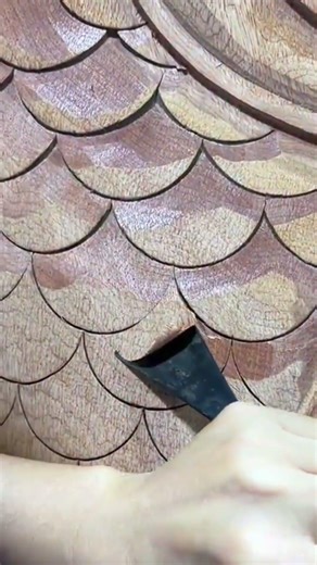 Carving and shaping intricate wooden scale patterns precisely daily using a professional manual wood