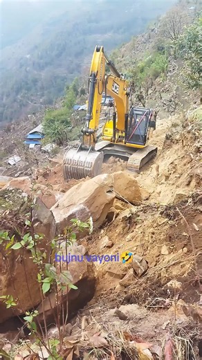 Excavator in Action: Digging on a Rocky Hillside