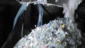 Plastic shredder. Recycling. Close-up of waste shredding process....