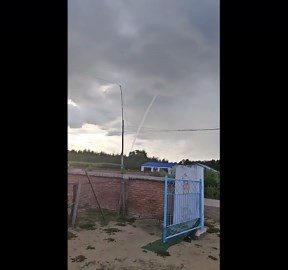 Waterspout rises from storm clouds over calm waters in Heilongjiang, China