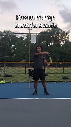 How to hit high brush forehands This is a powerful tool against pushers who are always hitting moon balls against you. Most players back up and hit low to high but you want to do this instead. Instead of backing up, use a high brush forehand. Prepare high, swing at the ball, but don't go THROUGH - instead, wrist across and fold your elbow across to "brush" the ball back. Do NOT swing down at the ball. Your goal is to hit thr ball back UP with SPIN. Watch the video to learn more! Comment or messa