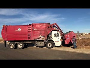 A Dempster Residential Front Loader Garbage Truck on Construction Waste