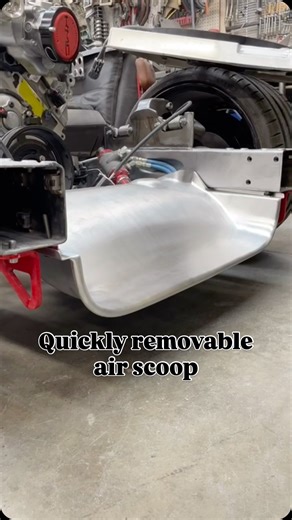 Kyle Kuhnhausen on Instagram: "So here’s the scoop… The air scoop on #serious66 is pretty cool, it can be removed with the push of two buttons and no tools and holds 250lb+ without deflection. The whole idea is to direct additional air up to the cooling stack ducting, but I’ve gotta admit,I also love the aggression it adds to the front end. Form & function, with easy serviceability. #hotrod #semahria2025 #semabattleofthebuilders #sema #sema25 #corvette #chevy #chevrolet #fabrication #kuhnhausenm