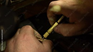 master of jewelry manually inserts gems into the frame of future jewelry. Working desk for craft jewelry making with professional tools. diamond ring on the jeweler's desktop