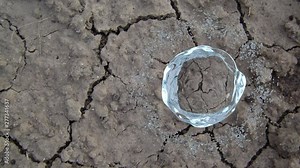 3D rendring of water forming a ring of drops around big liquid bubble on dry desert soil background. Ecology and environment awareness. Spinning flow. CG seamless loopable animation.
