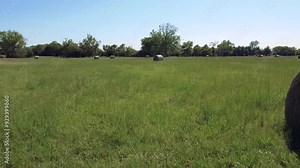 Drone footage of hay bales in a rural Oklahoma pasture