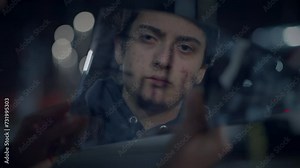 Young Lost Man with Suitcase Finding Broken Mirror on Urban Street at Night